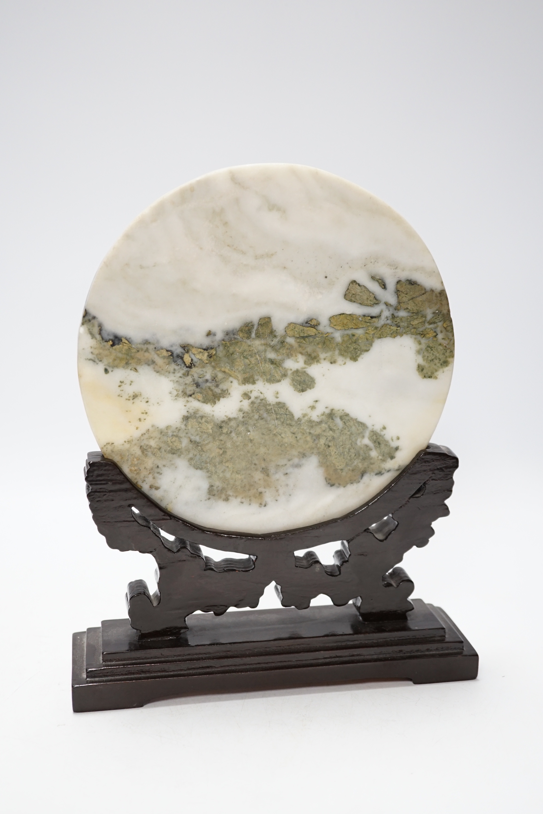 A 20th century Chinese marble plaque displaying cloud formations, on carved wood stand, 26cm